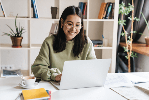Woman smiling in front of computer