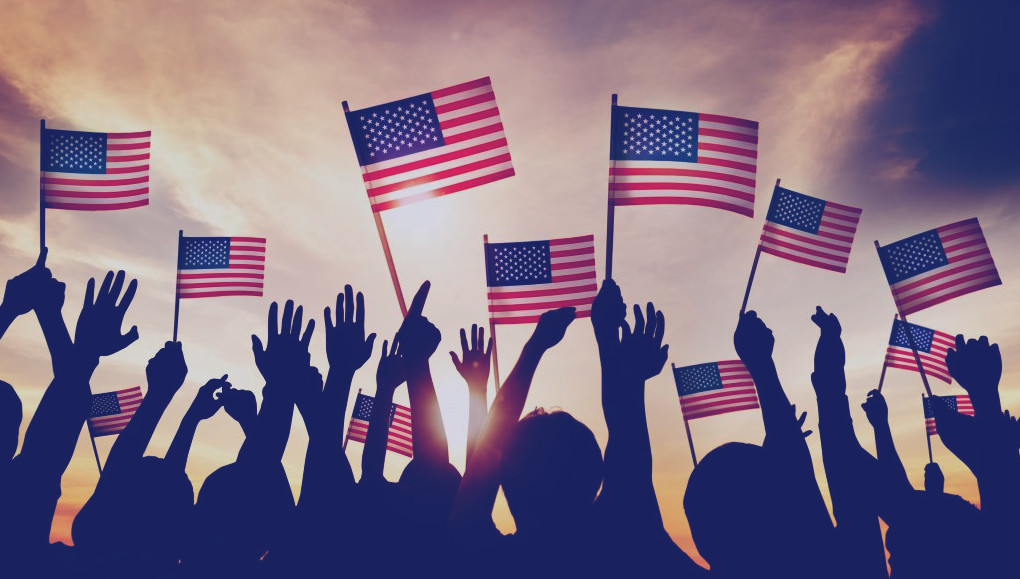 Silhouette of hands lifting up United States flags