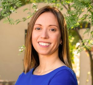 Attorney Jessica White in blue dress with botanical background